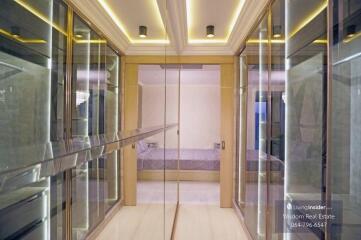 Modern bedroom with a large mirror closet door and warm lighting