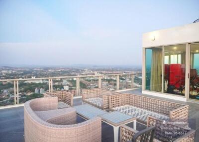 Spacious balcony with outdoor furniture and panoramic city view