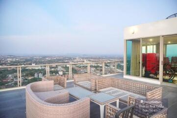 Spacious balcony with outdoor furniture and panoramic city view