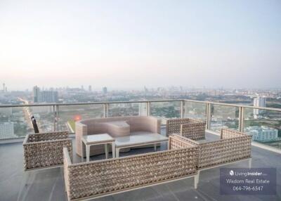 Spacious balcony with outdoor furniture and city skyline view