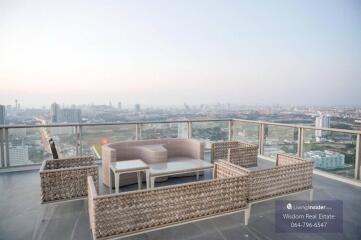 Spacious balcony with outdoor furniture and city skyline view
