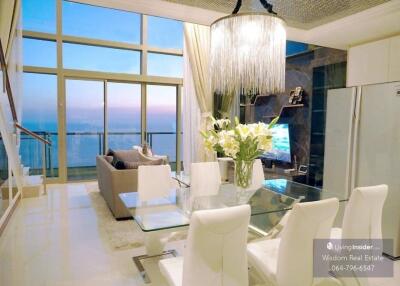 Elegant living room with a panoramic view, modern furnishings, and abundant natural light