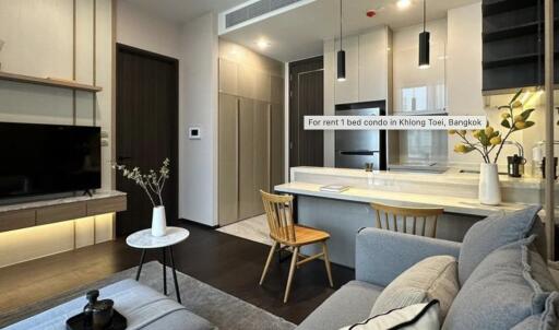 Modern living room with open kitchen design in a condo for rent in Klong Toei, Bangkok