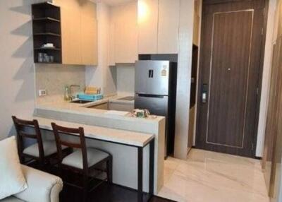 Compact modern kitchen with stainless steel appliances and breakfast bar