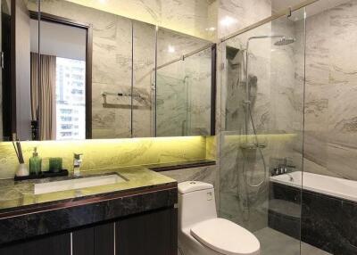 Modern bathroom with marble finishes and under cabinet lighting