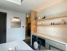 Modern kitchen interior with clean countertop, built-in appliances, and wooden shelves