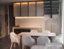 Modern kitchen with white cabinetry and a dining area with a table and chairs covered in protective plastic