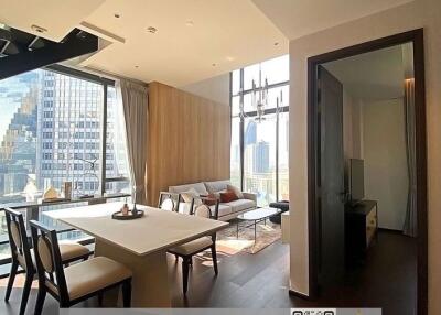 Modern living room with open dining area and city skyline view