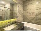 Modern bathroom with marble finishes, and glass shower