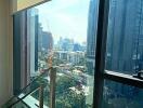 View from a high-rise apartment window showing surrounding cityscape and buildings