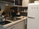 Modern kitchen interior with appliances and a white SMEG refrigerator