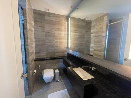 Modern bathroom with sleek design, dual vanity, and glass shower enclosure