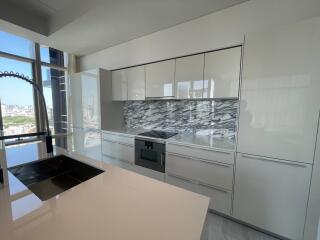 Modern kitchen with marble backsplash and city view