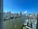 High-rise cityscape view with river and skyline under bright blue sky