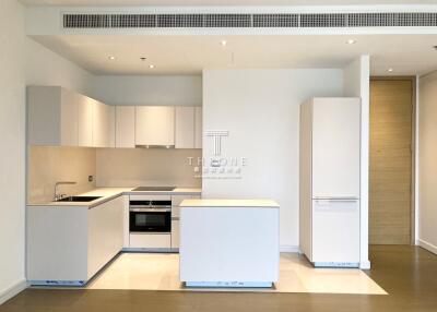 Modern kitchen with white cabinetry and stainless steel appliances