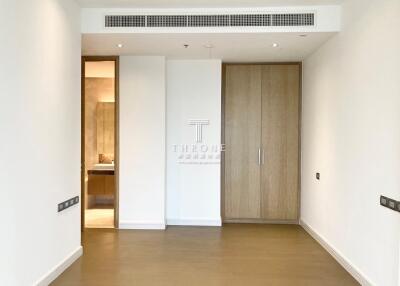 Minimalist bedroom interior with wooden wardrobe and white walls