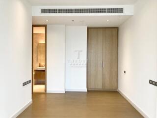 Minimalist bedroom interior with wooden wardrobe and white walls