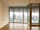 Spacious and bright unfurnished living room with large windows and city view