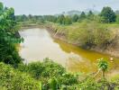 Rural landscape with a small water body surrounded by greenery