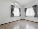 Empty bedroom with hardwood floors and air conditioning unit