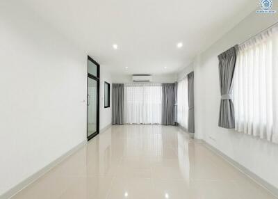 Spacious and bright empty living room with tiled flooring