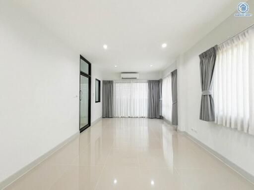 Spacious and bright empty living room with tiled flooring