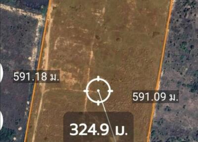 Aerial view of a large, vacant land plot with boundary dimensions