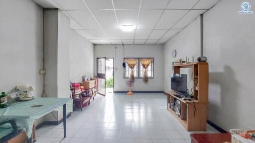 Spacious and well-lit living room with tiled flooring