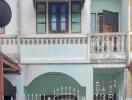 Classic two-story residential building with a gated entrance