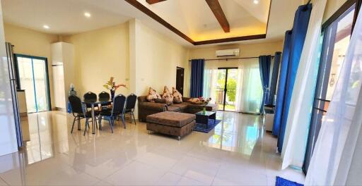 Spacious and well-lit living room with dining area