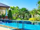 Tropical backyard with swimming pool and lush garden