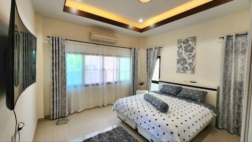 Spacious modern bedroom with king-sized bed and elegant interior design