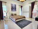 Spacious bedroom with elegant interior decor and abundant natural light