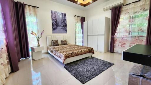 Spacious bedroom with elegant interior decor and abundant natural light