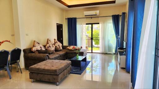 Spacious living room with natural light and modern furnishings