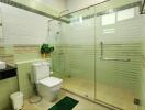 Spacious modern bathroom with walk-in shower and decorative tiling