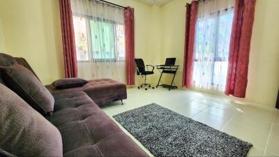 Spacious and well-lit living room with comfortable seating