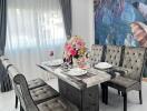 Elegant dining room with modern table set and tropical themed accent wall