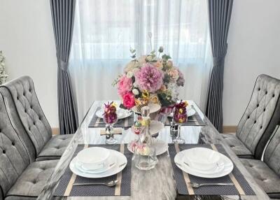 Elegant dining room with table set for two and floral centerpiece