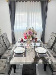 Elegant dining room with table set for two and floral centerpiece