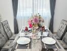 Elegant dining room with table set for two and floral centerpiece