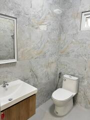 Modern bathroom with marbled tile walls and flooring