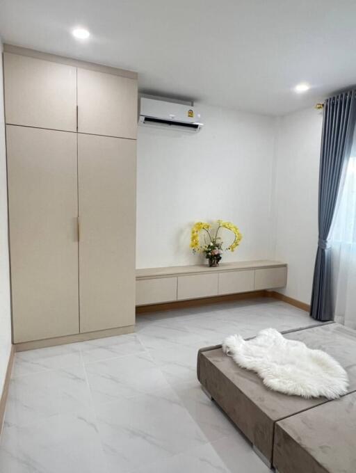 Modern bedroom with built-in wardrobe and air conditioning