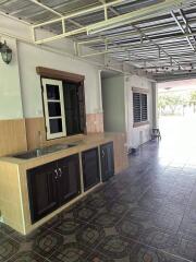 Partial view of an outdoor kitchen with modern amenities and tiled flooring