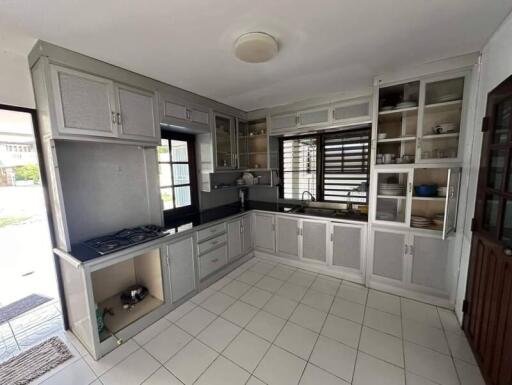 Spacious kitchen with modern cabinets and tiled flooring