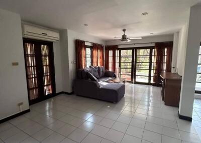 Spacious living room with tiled flooring and ample natural light