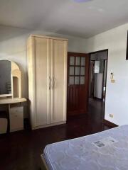 Spacious bedroom with wooden wardrobe and natural light