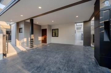 Spacious and modern carport with high ceiling and tiled flooring