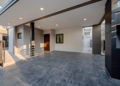 Spacious and modern carport with high ceiling and tiled flooring