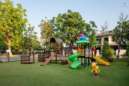 Spacious outdoor playground in a residential backyard with modern play equipment